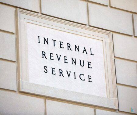 IRS sign on stone wall building, Kennedy Tax Solutions logo 